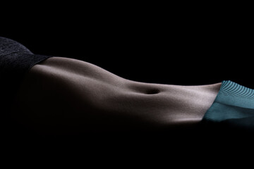 Close-up portrait of a female basketball player, highlighting the muscular contours in a sports outfit