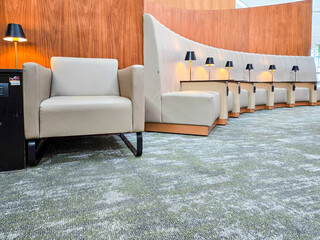 Row of comfortable chairs with lamps in airport business lounnge. Interior of Business Lounge in Istanbul Airport.