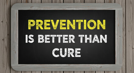 Naklejka premium Prevention Is Better Than Cure Message Written in Yellow and White on Chalkboard with Gray Wood Frame
