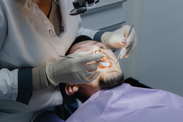 A young patient undergoing a dental examination in the office.