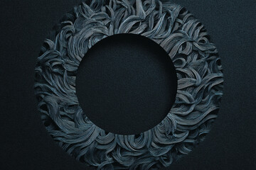 Intricate, dark blue and gray swirling line pattern forms a textured wreath on a black background with a shadow effect.