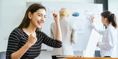 Happy business team celebrating success collaboration, teamwork achievement and partnership with diverse professionals raising hands together in joyful corporate celebration