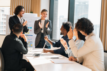 Happy business team celebrating success collaboration, teamwork achievement and partnership with diverse professionals raising hands together in joyful corporate celebration