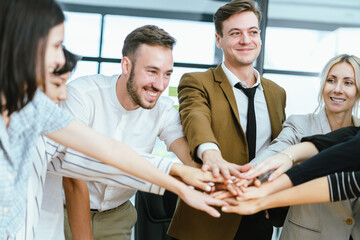 Business team showing unity success with hands together in office, teamwork collaboration and power motivation, diverse colleagues celebrating achievement corporate goal partnership