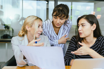Business team analyzing data and marketing strategy in modern office, brainstorming ideas for project success using laptops and charts, teamwork collaboration for corporate growth