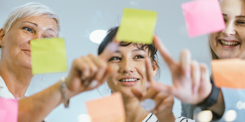 Business team analyzing data and marketing strategy in modern office, brainstorming ideas for project success using laptops and charts, teamwork collaboration for corporate growth