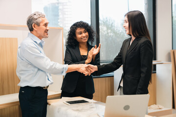 Professional business team having meeting discussing corporate strategy and project results using laptop in modern city environment showing teamwork leadership confident collaboration spirit