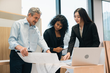 Professional business team having meeting discussing corporate strategy and project results using laptop in modern city environment showing teamwork leadership confident collaboration spirit