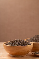Dried perilla seed in a bowl on wooden background