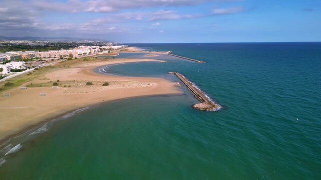 4K Aerial cinematic view of Cunit beach and Mediterranean Sea coastline in Catalonia, Spain. Wide sandy beach, turquoise water and summer vacation atmosphere.
