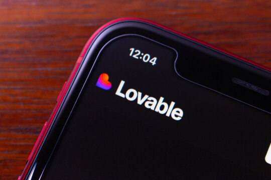 Quito, ECUADOR - Nov 25 2025 : Close-up of a smartphone displaying the Lovable AI app builder, symbolizing chat-based coding, no-code development, and modern technology.