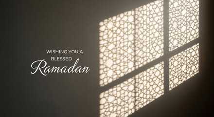 Ramadan text projected on dark wall through window pattern