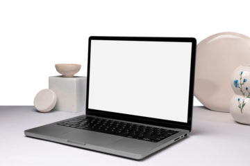 Modern laptop with white blank screen on desk with aesthetic decorations