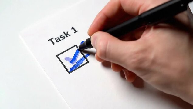 Hand writing a business plan or checklist on a white paper document using a pen in an office concept