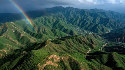 Breathtaking Aerial View of Lush Green Mountains with Rainbow