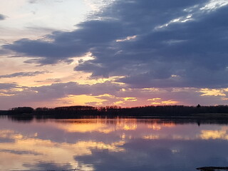 beautiful summer sunset over the lake in Saskatchewan Canada on a rural farm