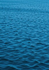 Obraz premium Deep blue ocean water texture, perfect for background use, featuring rippling surface patterns and clear, inviting colors ,travel ,clean ,ocean