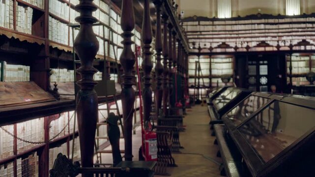Old library interior with defocused shelves and carved wooden balustrades, shallow focus background; background backplate copyspace calm.