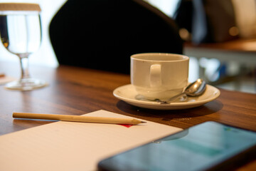Covered Water Glass and Coffee Cup on Wooden Conference Table