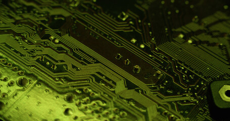 Mainboard chip. Electronic abstraction. Defocused green color round metal bright circuit board on gradient digital art light background.