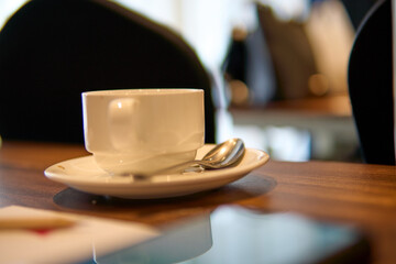 Coffee Cup, Notepad, and Pencil on Wooden Conference Table