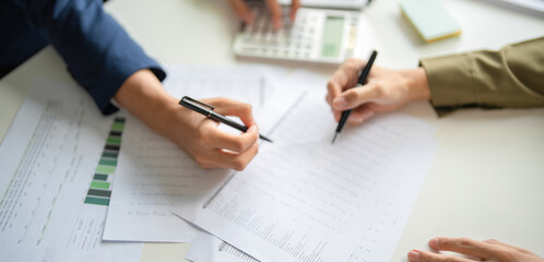 Businessmen working together at desk.