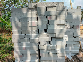 Piles of broken blocks form art. White bricks for building a house. Selective focus.
