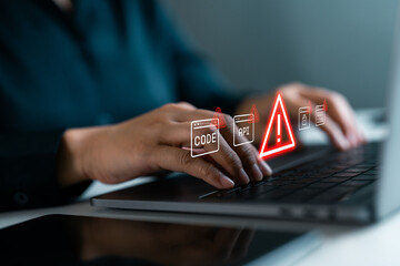 Hands typing on laptop with red warning icons. Concept of coding error, API failure, cybersecurity threat, and software vulnerability. Digital system alert and IT security risk prevention.