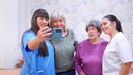 Caregiver and senior women taking selfie in nursing home