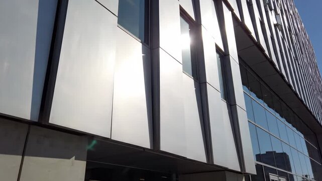 Modern Office Building Exterior with Aluminum Panels - This video showcases the exterior of a modern office building featuring textured aluminum architectural panels under bright daylight.