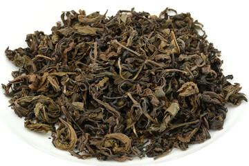 Pile of dried ferment tea leaves or miang tea isolated on white background.