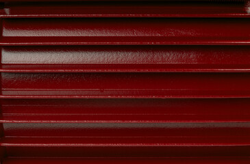 Red formed steel sheet for industrial use,  suitable as material texture or background.