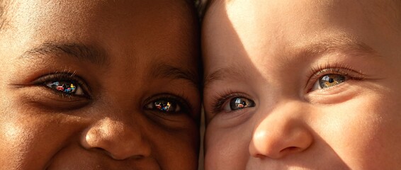 Children smile together in a close-up view during sunny day