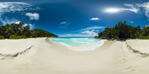 A tropical beach with turquoise waters, white sand and lush greenery under a clear blue sky. Anse Georgette beach. Praslin, Seychelles. VR 360.