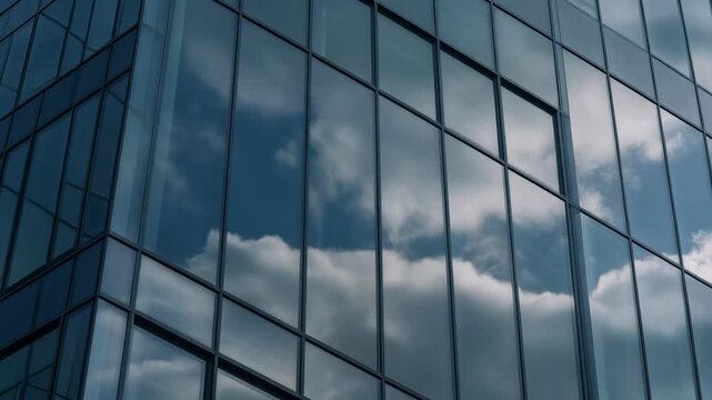  Close-up cinematic shot of moving clouds reflected on modern building glass surface, abstrac