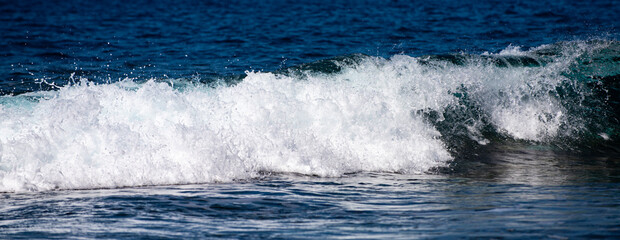 Rolling sea waves movement. Wave background. Soft sea waves. Abstract ocean texture. Transparent sea waves with foam sparkle.