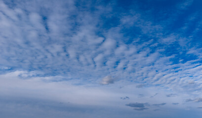 Relaxation theme sky. Horizon sky panorama. Nature view of fluffy white clouds on soft sky background. Bright blue sky wide soft clouds background. Air nature view wallpaper.