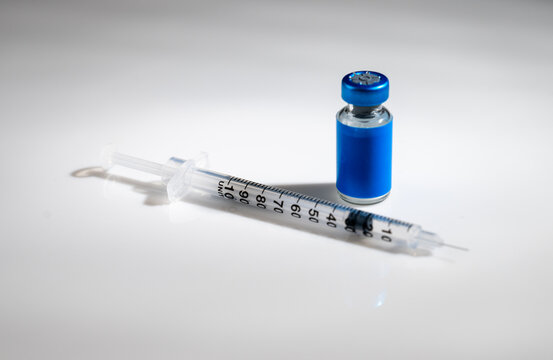 Close up of Glass Vile with Blue Label and Single Use Syringe