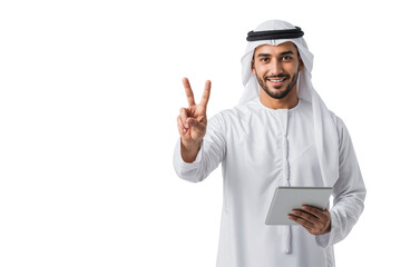 Smiling Arab businessman in a white thobe and ghutra holding a tablet and makes a peace sign, isolated on transparent background