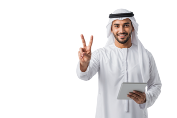 Smiling Arab businessman in a white thobe and ghutra holding a tablet and makes a peace sign, isolated on transparent background