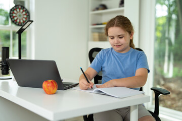 Child on online school lesson at home. Kid learning on laptop e-learning. Teen student learn lesson on laptop. Teenager study remotely using laptop. Teen student doing homework during online lesson.