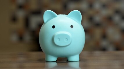 Transform finances into a playful challenge as a colorful piggy bank is filled with coins in a cozy kitchen. Discover creative ways to manage money and save effectively.