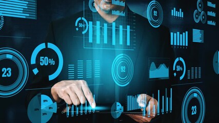 A businessman engaged in data analysis uses a digital tablet while surrounded by vivid animated charts and graphs, showcasing the importance of analytics in modern business. Xenic - Powered by Adobe