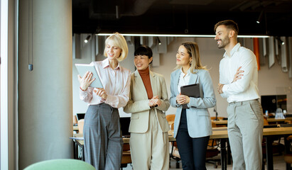 Team members discussing project progress in a modern office setting