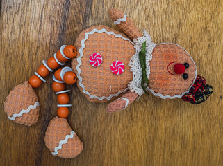 Gingerbread character hanging on wooden wall