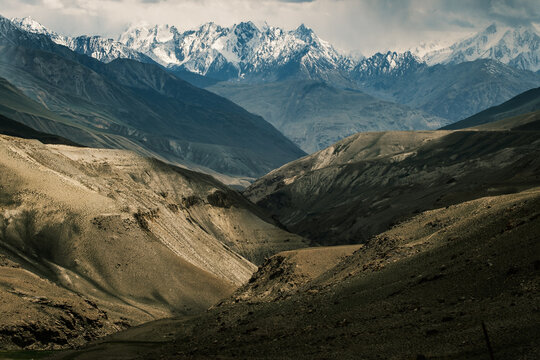 Aerial of the Wakhan Corridor in Afghanistan Tajikistan border , rugged Pamir Hindu Kush mountains, winding glacial rivers and remote high altitude valleys