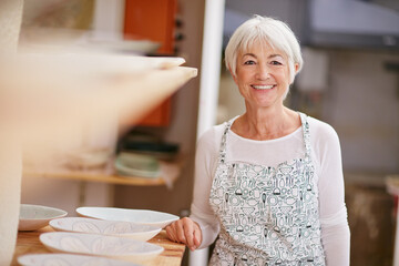 Ceramic, portrait and senior woman in workshop for pottery design, diy hobby and shelf for sculptures. Retirement, art studio and elderly person with smile for handicraft, learning skills or creative