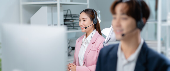 Portrait of smiling Businesswoman or Asian female operator speaking with client via headset,computer and talking in call center for contact us,help and online advice,engaging in communication concept