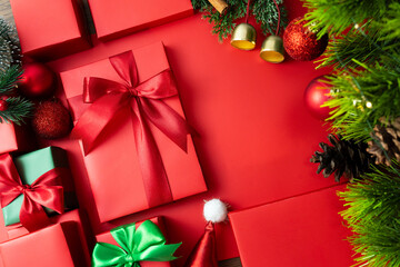 Festive red background with Christmas ornaments and gift boxes, holiday design for Christmas and New Year