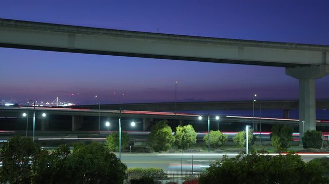 Time-lapse motion transforms I-80 and I-580 into glowing channels of activity, with Emeryville&rsquo;s urban backdrop adding depth to the continuous flow of East Bay traffic patterns at night
